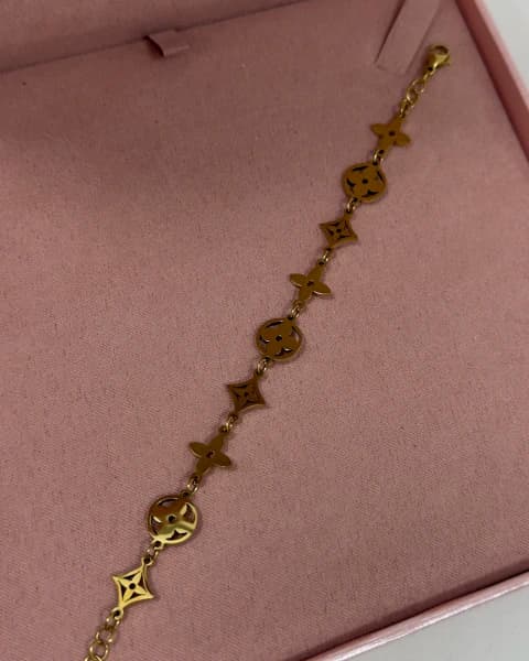 Pulseira de flores e estrelas aço dourado